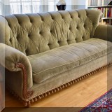 F10. Tufted velvet sofa with wood trim. 40”h x 90”w x 41”d 